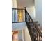 Staircase with carpet, dark wood banister and iron spindles at 19889 W Annika Dr, Litchfield Park, AZ 85340