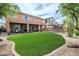 Expansive backyard with a manicured lawn, covered patio, and desert landscaping for outdoor enjoyment at 2210 W Calle Del Sol --, Phoenix, AZ 85085