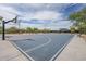 Community basketball court with multiple hoops, shaded benches, and clear blue skies at 2210 W Calle Del Sol --, Phoenix, AZ 85085