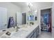Bathroom boasts double sinks, a large mirror, and a shower with decorative curtain at 2210 W Calle Del Sol --, Phoenix, AZ 85085