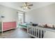 Bright, spacious bedroom with two twin beds, a window, and wood-look tile flooring at 2210 W Calle Del Sol --, Phoenix, AZ 85085