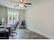 Bedroom featuring wood floors, ceiling fan, and a window with natural lighting at 2210 W Calle Del Sol --, Phoenix, AZ 85085