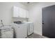 Well-equipped laundry room featuring a modern washer and dryer with overhead cabinets at 2210 W Calle Del Sol --, Phoenix, AZ 85085
