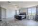 Primary bedroom with wood-look tile flooring, and scenic views through dual windows at 2210 W Calle Del Sol --, Phoenix, AZ 85085