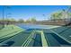 Well-maintained tennis court with lighting and a smooth surface ready for a match at 2210 W Calle Del Sol --, Phoenix, AZ 85085