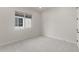 Neutral bedroom showcasing a plush carpet, large window and white walls at 22528 E San Tan Blvd, Queen Creek, AZ 85142