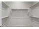 Walk-in closet features ample shelving and neutral carpeting at 22528 E San Tan Blvd, Queen Creek, AZ 85142
