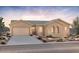 Charming single-story home featuring a two-car garage and desert landscaping against a beautiful sunset backdrop at 22528 E San Tan Blvd, Queen Creek, AZ 85142