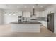 Modern kitchen featuring white cabinets, stainless steel appliances, and a large island at 22528 E San Tan Blvd, Queen Creek, AZ 85142