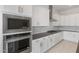 Close-up of a modern kitchen with stainless steel appliances and white cabinets at 22528 E San Tan Blvd, Queen Creek, AZ 85142