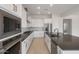 A modern kitchen showcases white cabinets, stainless steel appliances, and gray countertops at 22528 E San Tan Blvd, Queen Creek, AZ 85142