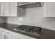 Close-up of the gas cooktop and backsplash in a modern kitchen at 22528 E San Tan Blvd, Queen Creek, AZ 85142