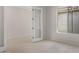 Bright living area featuring neutral paint, large windows, light tile flooring and a glass panel door at 22528 E San Tan Blvd, Queen Creek, AZ 85142