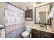 Well-lit bathroom featuring a vanity with stone countertop and a floral shower curtain at 22783 W Cantilever St, Buckeye, AZ 85326