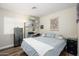 Well-lit bedroom featuring a comfortable bed and open shelving at 22783 W Cantilever St, Buckeye, AZ 85326
