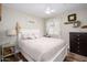 Serene bedroom with a queen-size bed, soft colors, and a decorative wreath at 22783 W Cantilever St, Buckeye, AZ 85326