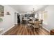 Bright dining area with wood table, chairs, modern light fixture, and easy access to the kitchen at 22783 W Cantilever St, Buckeye, AZ 85326