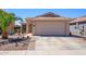 Charming single-story home exterior featuring a two-car garage, desert landscaping, and a tile roof at 22783 W Cantilever St, Buckeye, AZ 85326