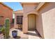 Front entrance with a secure door, decorative window, and desert landscaping at 22783 W Cantilever St, Buckeye, AZ 85326