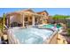 Inviting backyard with hot tub, covered patio, and outdoor bar, perfect for relaxation and entertaining at 22783 W Cantilever St, Buckeye, AZ 85326