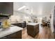 Open concept kitchen with dining area, island, stainless steel appliances, and sliding door access to patio at 22783 W Cantilever St, Buckeye, AZ 85326
