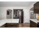 Open kitchen with white counters, dark cabinets, and stainless appliances, flowing into adjacent spaces at 22783 W Cantilever St, Buckeye, AZ 85326