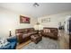 Inviting living room with comfortable leather seating, stylish rug, and warm lighting at 22783 W Cantilever St, Buckeye, AZ 85326