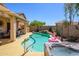 Pool with a waterfall feature, hot tub, covered patio, and desert landscaping in the backyard at 22783 W Cantilever St, Buckeye, AZ 85326