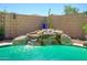 Inviting pool with a rock waterfall feature and clear turquoise water on a sunny day at 22783 W Cantilever St, Buckeye, AZ 85326