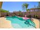 Backyard pool oasis featuring a waterfall and a playful pink flamingo float on a sunny day at 22783 W Cantilever St, Buckeye, AZ 85326