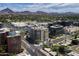 Breathtaking aerial view showcasing the city skyline, nearby mountains, and lush green landscaping at 2402 E Esplanade Ln # 1101, Phoenix, AZ 85016