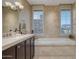 Bathroom with a large soaking tub and tile surround at 2402 E Esplanade Ln # 1101, Phoenix, AZ 85016