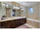 Bathroom boasts a double vanity, soaking tub, shower, and neutral tile at 2402 E Esplanade Ln # 1101, Phoenix, AZ 85016