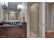 Bathroom featuring a vanity with a vessel sink, a large mirror, and a glass-enclosed shower at 2402 E Esplanade Ln # 1101, Phoenix, AZ 85016