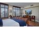 Bedroom showcasing shuttered windows, a TV, and a beautiful leather bed frame at 2402 E Esplanade Ln # 1101, Phoenix, AZ 85016