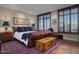 Bedroom with hard wood flooring, leather bed, and a chest at the end of the bed at 2402 E Esplanade Ln # 1101, Phoenix, AZ 85016