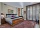 Bedroom with wood floors, decorative rug, art and a large window at 2402 E Esplanade Ln # 1101, Phoenix, AZ 85016