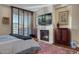 Bedroom has a fireplace and a large window with wooden shutters at 2402 E Esplanade Ln # 1101, Phoenix, AZ 85016