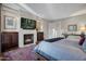 Comfortable bedroom features a fireplace, TV, and decorative furnishings at 2402 E Esplanade Ln # 1101, Phoenix, AZ 85016