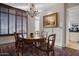 Chandelier hangs over the dining room, filled with wood furniture and natural light at 2402 E Esplanade Ln # 1101, Phoenix, AZ 85016