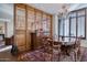 Elegant dining room features a chandelier and ornate wood detailing creating a warm, inviting space at 2402 E Esplanade Ln # 1101, Phoenix, AZ 85016
