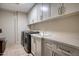 Laundry room with modern white cabinetry and appliances at 2402 E Esplanade Ln # 1101, Phoenix, AZ 85016