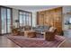 Spacious living room with hardwood floors, a wooden screen, and abundant natural light at 2402 E Esplanade Ln # 1101, Phoenix, AZ 85016