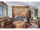 Comfortable living room with hardwood floors, wooden screen accent wall, and large windows at 2402 E Esplanade Ln # 1101, Phoenix, AZ 85016