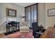 Office with a desk, chair, and shuttered window offering city views at 2402 E Esplanade Ln # 1101, Phoenix, AZ 85016