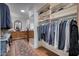 Spacious walk-in closet with clothing racks, shelving, full-length mirror, and wood dresser at 2402 E Esplanade Ln # 1101, Phoenix, AZ 85016