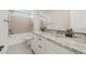 Bathroom with granite countertops, dual sinks, and a tub with tiled walls at 26160 S 225Th Way, Queen Creek, AZ 85142