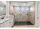 Luxurious walk-in shower with black floor, stylish tile and glass partition at 26160 S 225Th Way, Queen Creek, AZ 85142