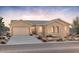 Charming one-story home featuring a neutral color palette, arched windows and desert landscaping at 26160 S 225Th Way, Queen Creek, AZ 85142