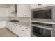 Gourmet kitchen features white cabinets, granite countertops, stainless steel appliances, and stylish backsplash at 26160 S 225Th Way, Queen Creek, AZ 85142